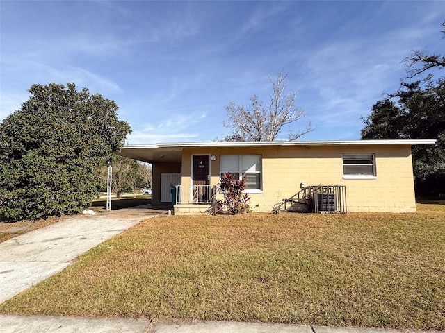 view of front of property with a front lawn and a carport