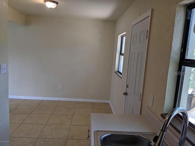 interior space featuring sink and light tile patterned floors