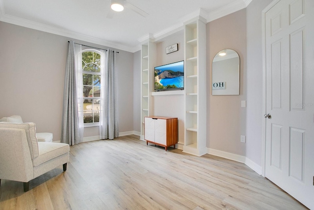 living area featuring crown molding and light hardwood / wood-style floors