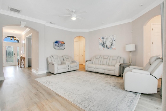 living room with ceiling fan, light hardwood / wood-style flooring, and ornamental molding