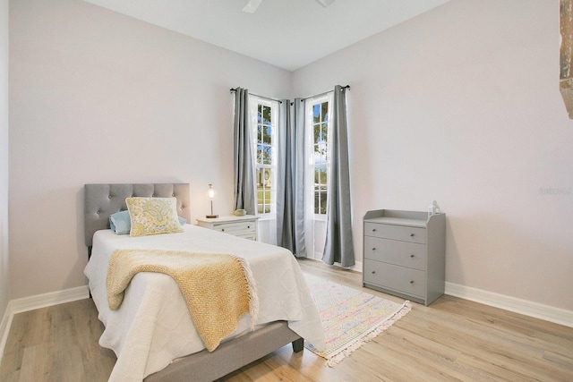 bedroom with light hardwood / wood-style flooring and ceiling fan