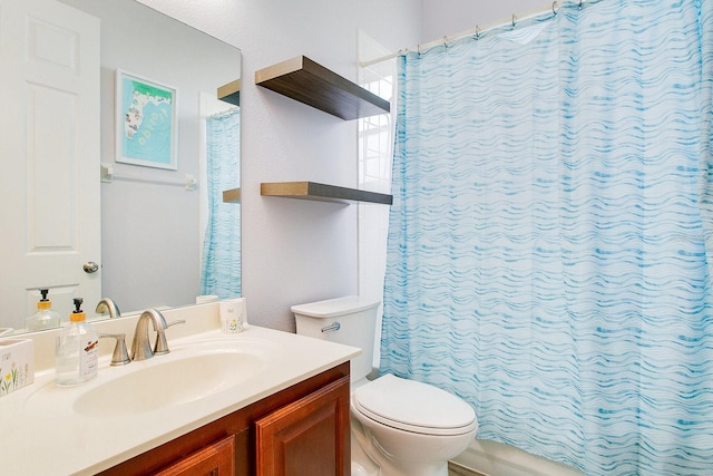 bathroom with vanity, toilet, and walk in shower