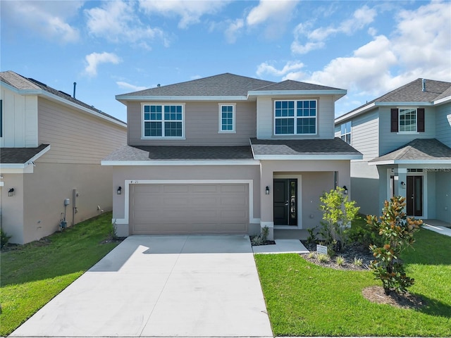 view of front of home with a front lawn and a garage