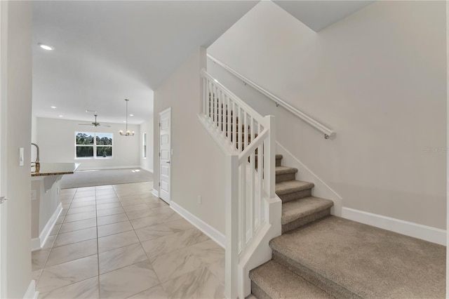 stairway featuring carpet flooring and ceiling fan