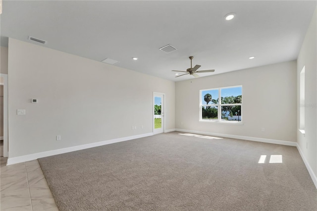 spare room featuring ceiling fan and light carpet