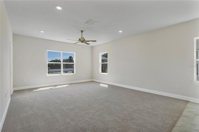 carpeted empty room featuring ceiling fan