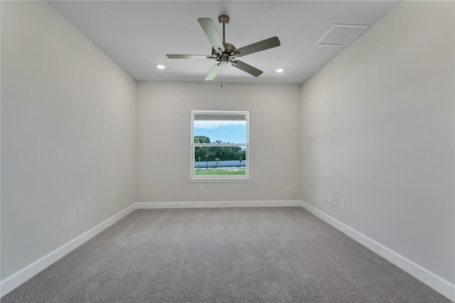 spare room featuring ceiling fan and carpet