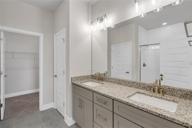 bathroom with tile patterned flooring, vanity, and a shower with shower door