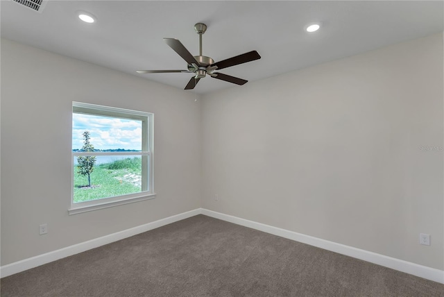 empty room with ceiling fan and carpet