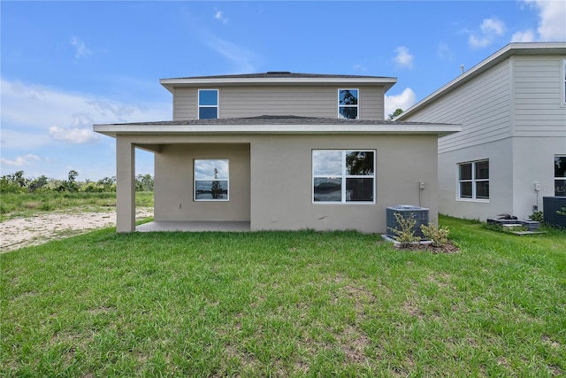 rear view of house with a yard, a patio, and central AC unit