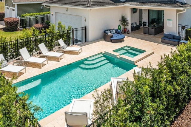 view of pool with an in ground hot tub, outdoor lounge area, and a patio