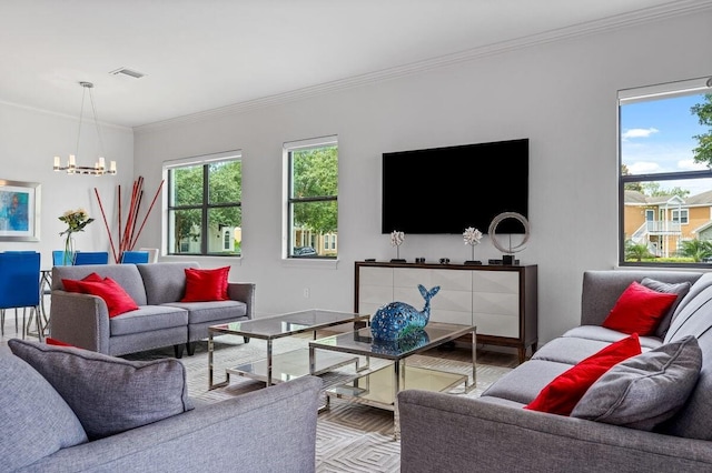 living room featuring crown molding and a chandelier