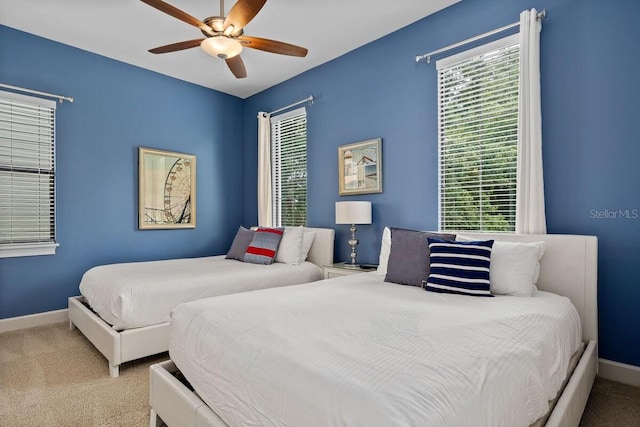 bedroom with light colored carpet and ceiling fan