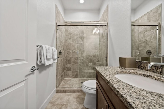 bathroom featuring walk in shower, vanity, and toilet