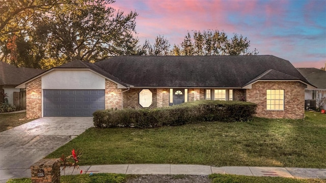 ranch-style home with a garage, a yard, and central air condition unit