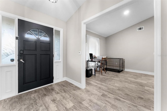 entrance foyer featuring lofted ceiling and light wood-type flooring