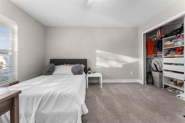 carpeted bedroom featuring a closet, multiple windows, and ceiling fan