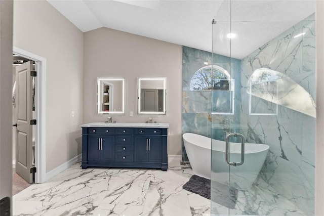 bathroom with vanity, vaulted ceiling, and a tub