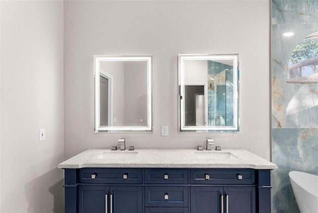 bathroom featuring vanity and a bath