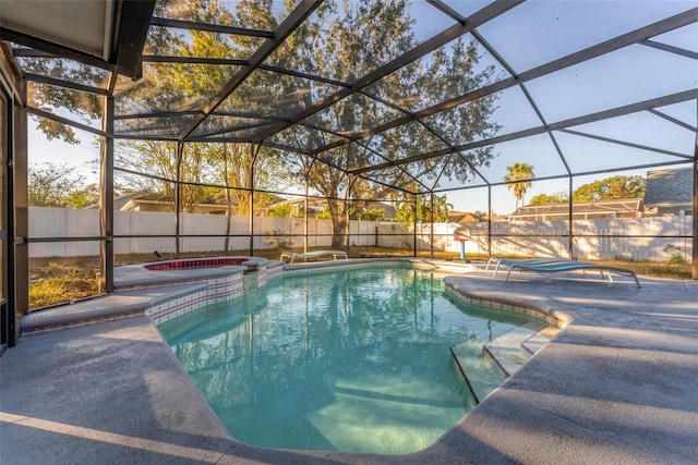 view of swimming pool featuring a patio area, a lanai, and an in ground hot tub