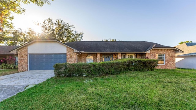 ranch-style home featuring a garage and a front lawn