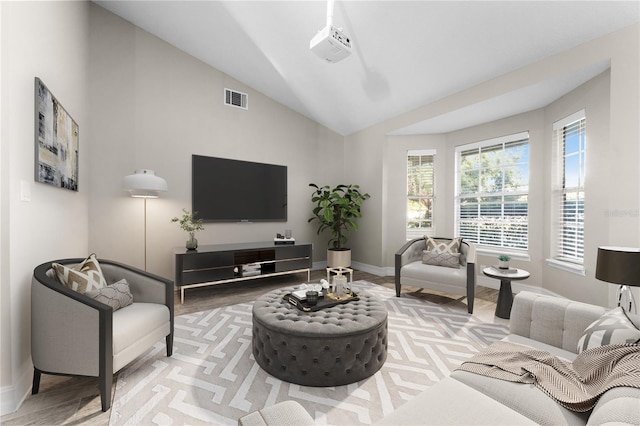 living room with hardwood / wood-style floors and vaulted ceiling