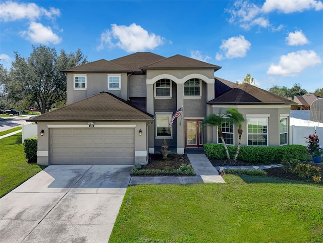 view of front facade with a garage and a front lawn