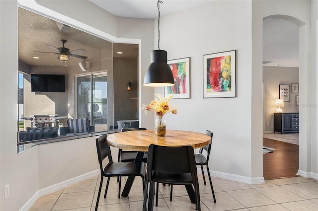 dining room with ceiling fan, light tile patterned floors, and a textured ceiling