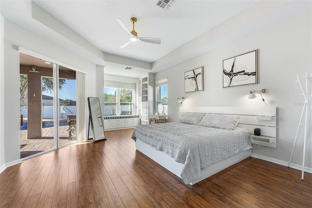 bedroom featuring radiator, dark hardwood / wood-style flooring, access to outside, and ceiling fan