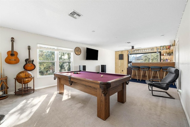 rec room featuring billiards, light carpet, and bar