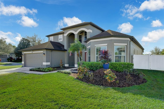 mediterranean / spanish house with a front lawn and a garage