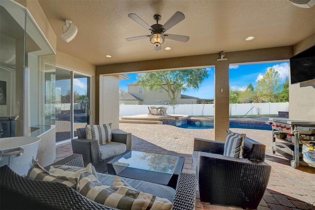 view of patio with a fenced in pool, ceiling fan, and an outdoor living space