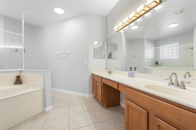 bathroom with tile patterned floors, vanity, and plus walk in shower