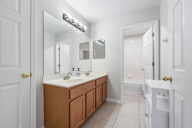 bathroom featuring a textured ceiling, vanity, and tile patterned floors