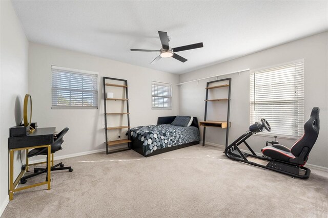 bedroom featuring ceiling fan and light carpet