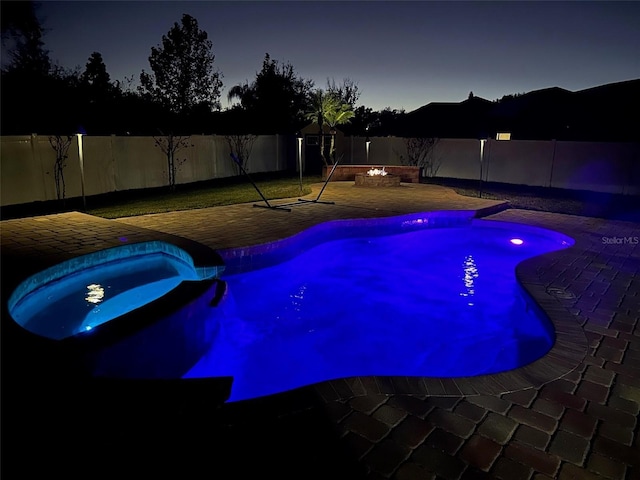 view of pool featuring an in ground hot tub, a fire pit, and a patio area