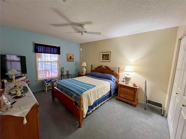 bedroom with ceiling fan, a closet, carpet, and a textured ceiling