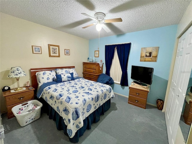 carpeted bedroom with ceiling fan, a textured ceiling, and a closet