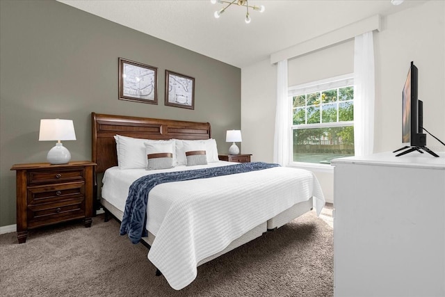 bedroom featuring light colored carpet and an inviting chandelier