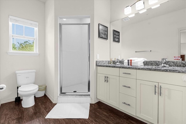 bathroom featuring vanity, hardwood / wood-style flooring, toilet, and an enclosed shower