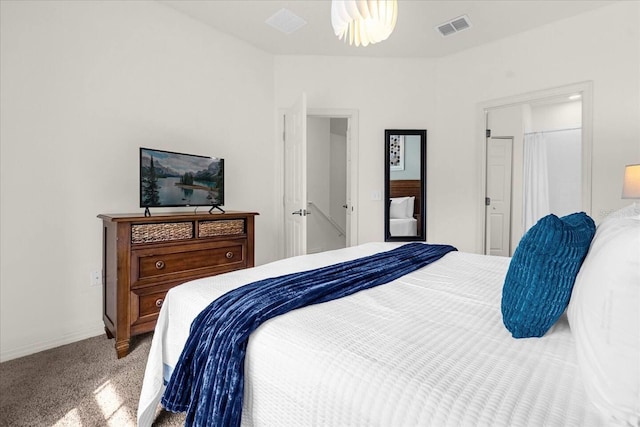 carpeted bedroom featuring ensuite bathroom