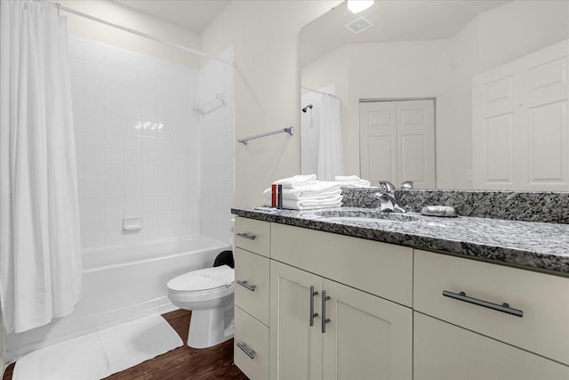 full bathroom featuring toilet, vanity, hardwood / wood-style flooring, and shower / tub combo with curtain