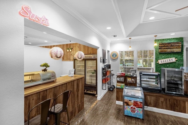 interior space featuring pendant lighting, dark hardwood / wood-style flooring, lofted ceiling, and crown molding