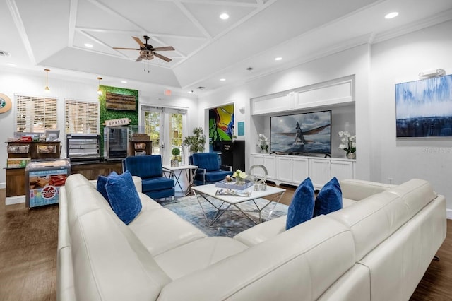 living room with ceiling fan, crown molding, dark wood-type flooring, and coffered ceiling