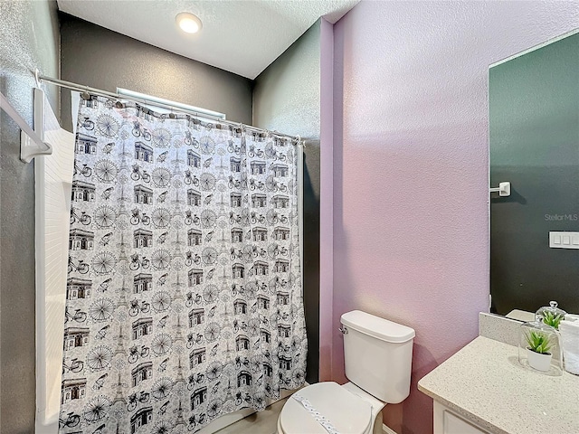 bathroom featuring vanity, toilet, and curtained shower