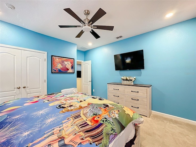 bedroom with light carpet, a closet, and ceiling fan