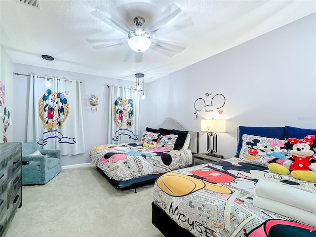 bedroom with a textured ceiling, ceiling fan, and light carpet