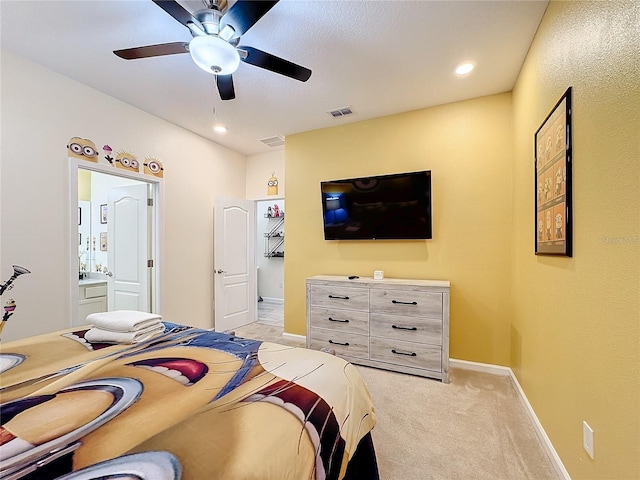 carpeted bedroom featuring ensuite bathroom and ceiling fan