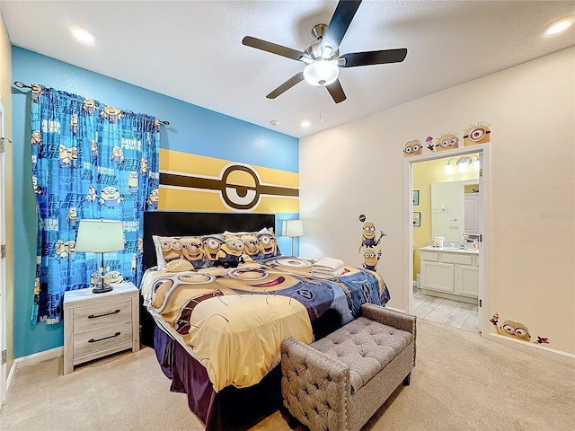 carpeted bedroom featuring ensuite bath and ceiling fan