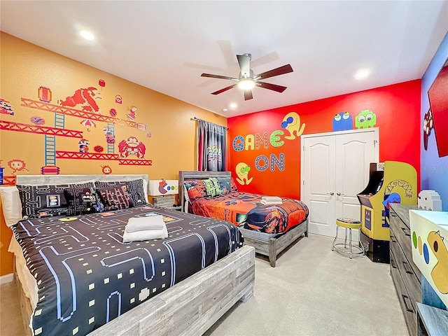 bedroom with light carpet, a closet, and ceiling fan